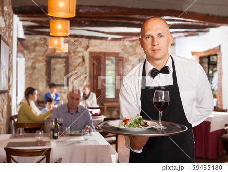 Waiter holding tray with dish Waiter holding tray with dish 59435480