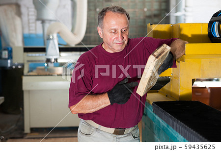Foreman checks metal part on the wooden form 59435625