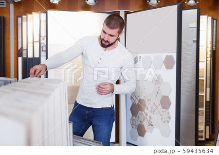 guy selecting ceramic tile 59435634