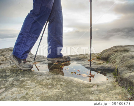 Hiker walks on Trail in warm trousers and 59436373