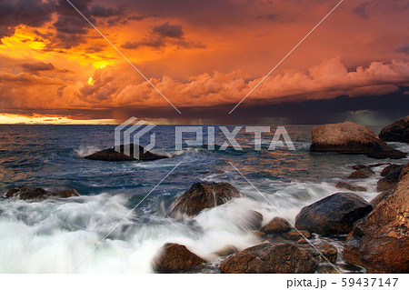 Sunset on the rocky shore of tropical sea 59437147
