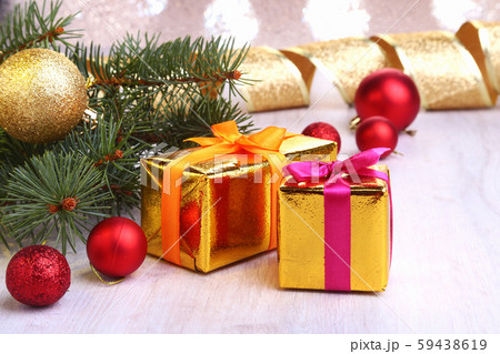 Christmas decoration with gift boxes, colorful christmas balls and christmas tree on a blurry Christmas decoration with gift boxes, colorful christmas balls and christmas tree on a blurry 59438619