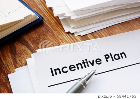 Incentive Plan and stack of papers in the office. 59441765