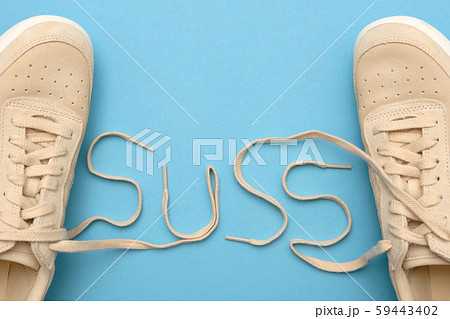 Sneakers with laces in suss text. Detective concept Sneakers with laces in suss text. Detective concept 59443402