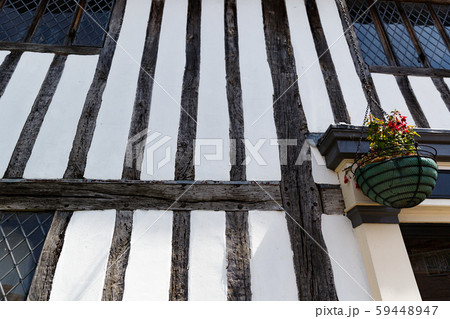 countryside street wall with flowers , wooden bars in traditional British style 59448947