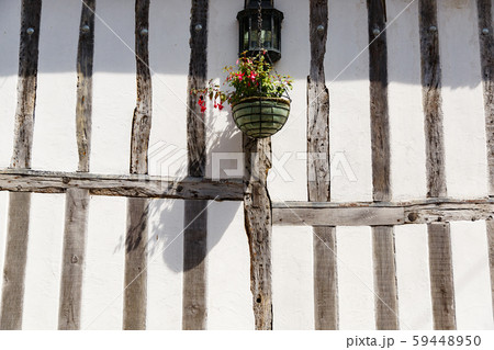 countryside street wall with flowers , wooden bars in traditional British style 59448950
