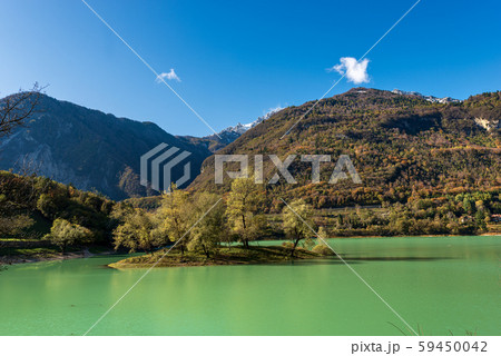 Lago di Tenno - Small lake with island in Italian Alps Trentino Italy 59450042