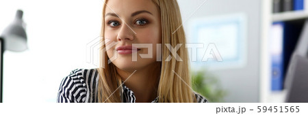 Beautiful smiling female ceo at worktable looking in camera Beautiful smiling female ceo at worktable looking in camera 59451565