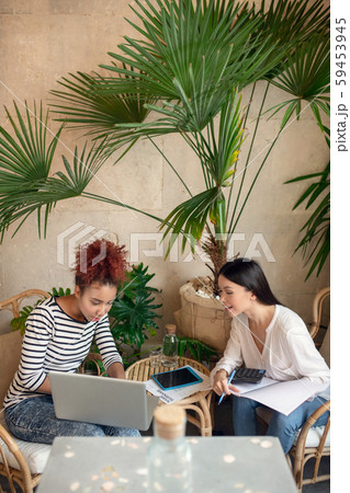 Two women feeling involved in making financial report 59453945