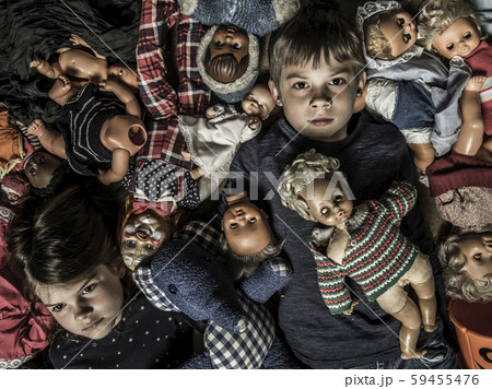 Scary children in a pile of creepy dolls 59455476