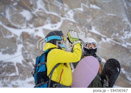 Photo of two young athletes in helmet and mask doing handshake on background of mountain Photo of two young athletes in helmet and mask doing handshake on background of mountain 59456567