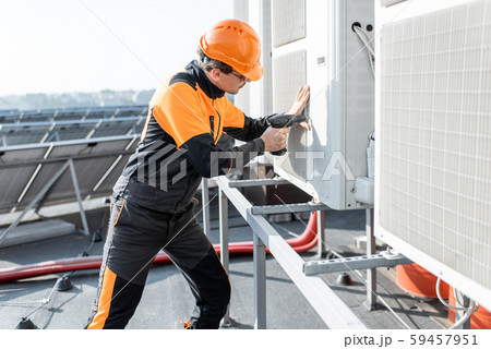 Workman installing outdoor unit of the air conditioner 59457951