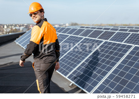 Well-equipped workman on a solar station 59458271