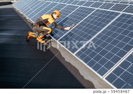 Worker installing solar panels Worker installing solar panels 59458487