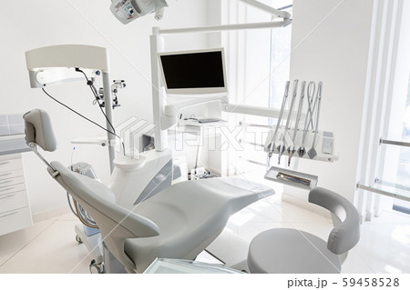 Modern empty dental chair with dental equipment 59458528