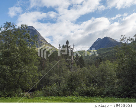 View on turquoise mountain river Slettvikelva with forest and mountains, Norway. Blue sky white View on turquoise mountain river Slettvikelva with forest and mountains, Norway. Blue sky white 59458653