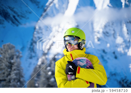 Photo of sportive man with snowboard against background of mountains Photo of sportive man with snowboard against background of mountains 59458710