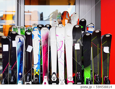 Several multicolored skiing at rental point. 59458814