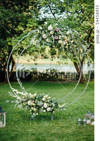 Arch for the wedding ceremony, decorated with cloth and flowers Arch for the wedding ceremony, decorated with cloth and flowers 59458955