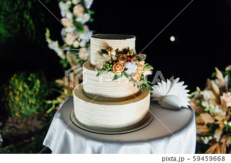 wedding cake three floors with fruit outside in the evening 59459668