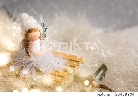 Toy angel on small sledge with Christmas Toy angel on small sledge with Christmas 59459804