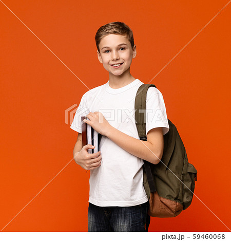 Teen boy ready for getting education, smiling with books and backpack 59460068