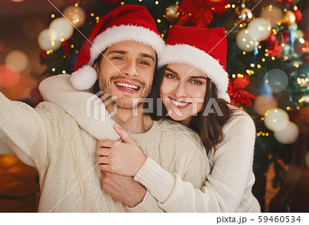 Sweet couple taking selfie on Christmas eve 59460534