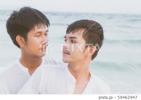 Homosexual portrait young asian couple standing hug and look together on beach 59462947