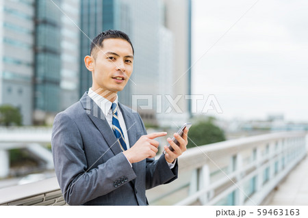 ビジネスマン(若い男性、高層ビル、スマホ、屋外 ビジネスマン(若い男性、高層ビル、スマホ、屋外 59463163