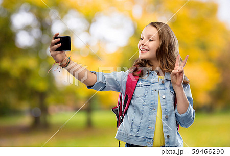 teenage student girl taking selfie by smartphone teenage student girl taking selfie by smartphone 59466290