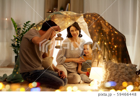 happy family playing in kids tent at night at home 59466448