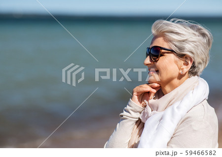 portrait of senior woman in sunglasses on beach 59466582