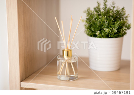 aroma reed diffuser and pot flower on wooden shelf aroma reed diffuser and pot flower on wooden shelf 59467191