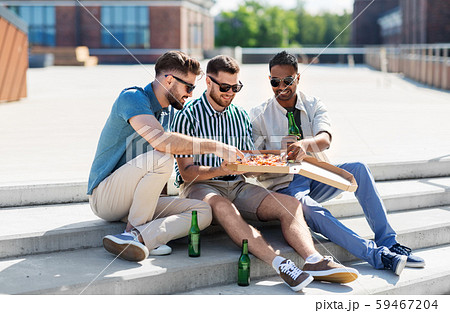 male friends eating pizza with beer on street 59467204
