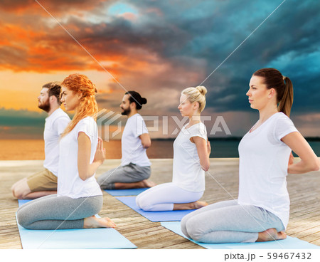 people making yoga in hero pose outdoors 59467432