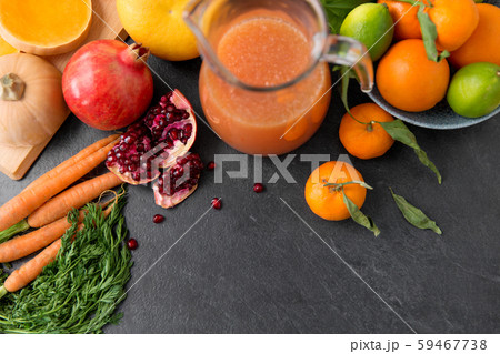 glass jug of juice with fruits and vegetables 59467738