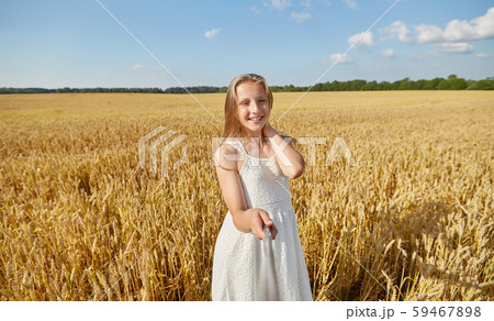 happy girl taking selfie on cereal field 59467898