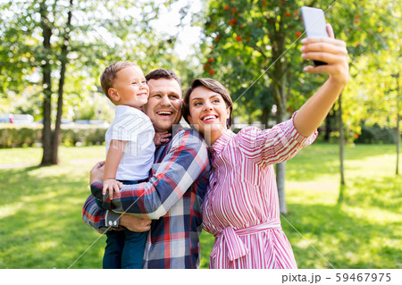 happy family taking selfie at summer park happy family taking selfie at summer park 59467975