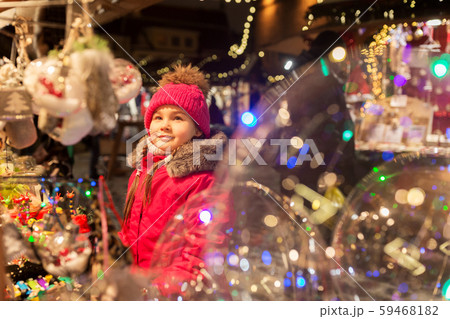 girl choosing christmas decorations at market 59468182