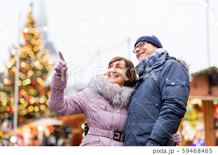 happy senior couple hugging at christmas market 59468465