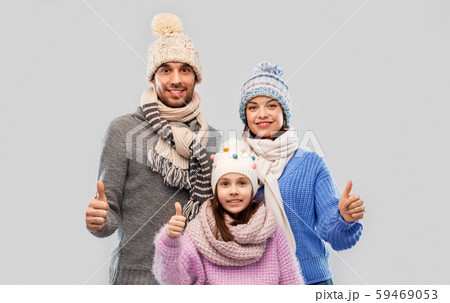 happy family in winter clothes on grey background 59469053