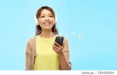 asian woman in headphones listening to music asian woman in headphones listening to music 59469094