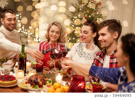 friends celebrating christmas and drinking wine friends celebrating christmas and drinking wine 59469095