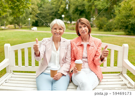 senior women with coffee showing thumbs up at park senior women with coffee showing thumbs up at park 59469173