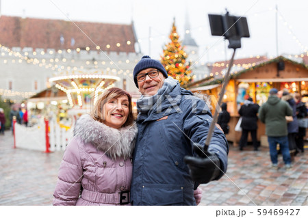 senior couple taking selfie at christmas market 59469427