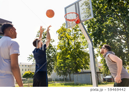 group of male friends playing street basketball 59469442