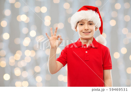 smiling boy in santa helper hat showing ok gesture smiling boy in santa helper hat showing ok gesture 59469531