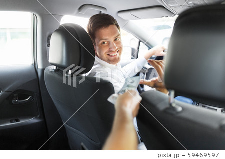 male car driver taking money from passenger male car driver taking money from passenger 59469597