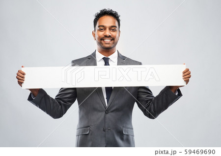 smiling indian businessman with white banner 59469690
