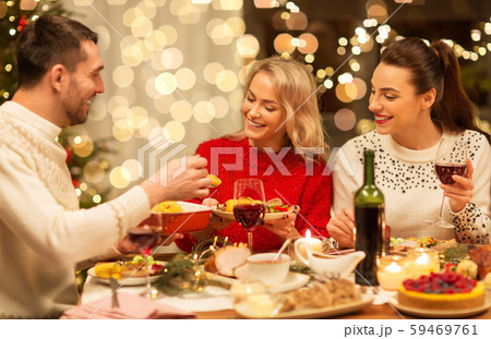happy friends having christmas dinner at home happy friends having christmas dinner at home 59469761
